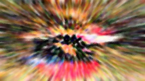 Abstrakte Komposition aus bunten, radial von der Mitte nach außen laufenden Farbstreifen in Rot, Gelb, Grün und Blau, im Zentrum ein dunkler, unscharfer Knoten.