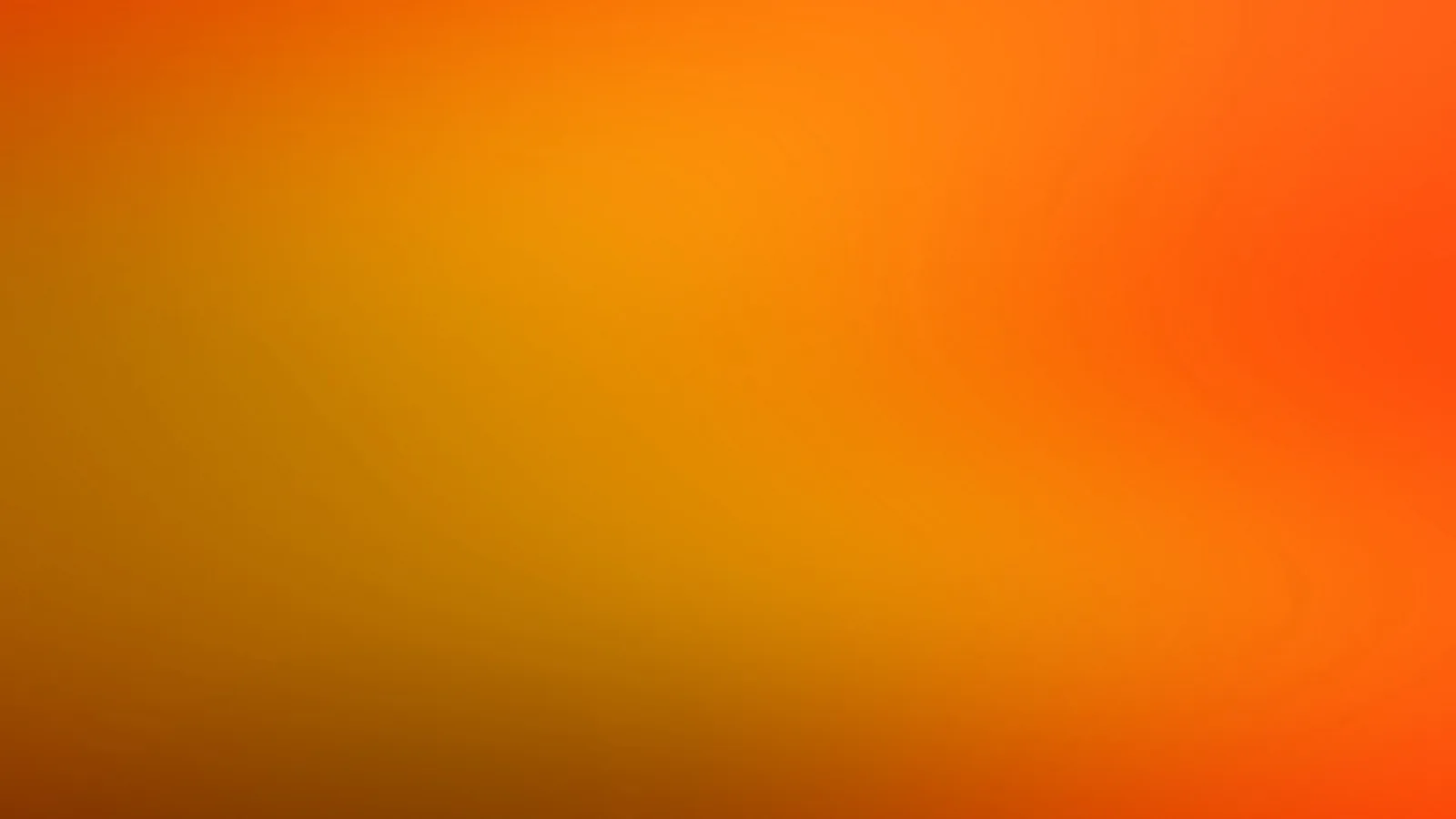 Weich verschwommener Farbverlauf von Orange über Gelb bis Rotorange, rechts oben intensiver, links unten dunkler und bräunlich.