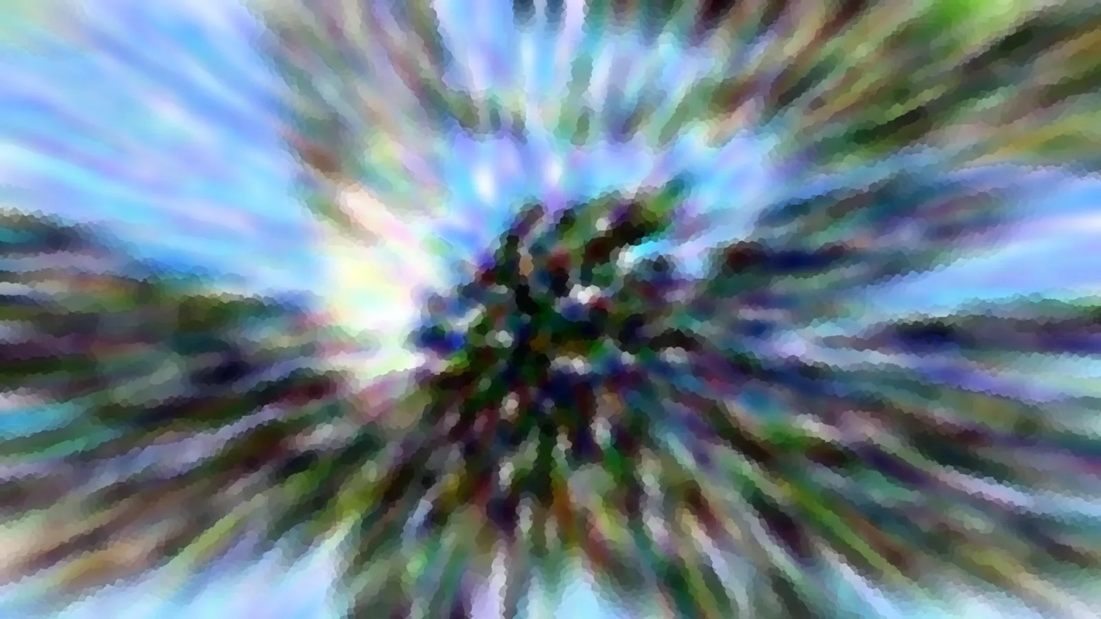 Stark verwischter Baum vor blauem Himmel, Farbschlieren laufen radial von der Bildmitte nach außen.