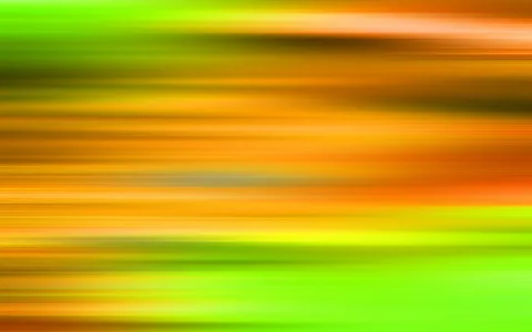 Abstrakte horizontale Streifen in Grün, Orange und Gelb, die sich unscharf über die ganze Bildfläche ziehen.