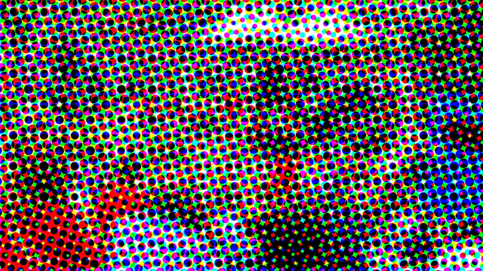Dichtes Raster aus kleinen, farbigen Punkten in Rot, Grün, Blau, Gelb und Cyan, durchsetzt von schwarzen Punkten, die in der Mitte und unten rechts eine dunkle Fläche bilden.