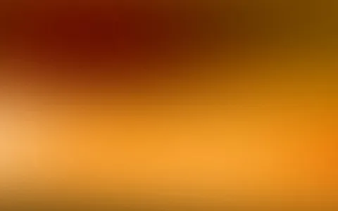 Unscharfer Farbverlauf von dunklem Rot oben links über Orange bis zu hellem Gelb unten links.