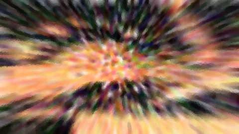 Abstraktes Bild mit radialer Bewegungsunschärfe in Orange, Grün und Schwarz, Farbstreifen laufen von einem hellen Zentrum nach außen.