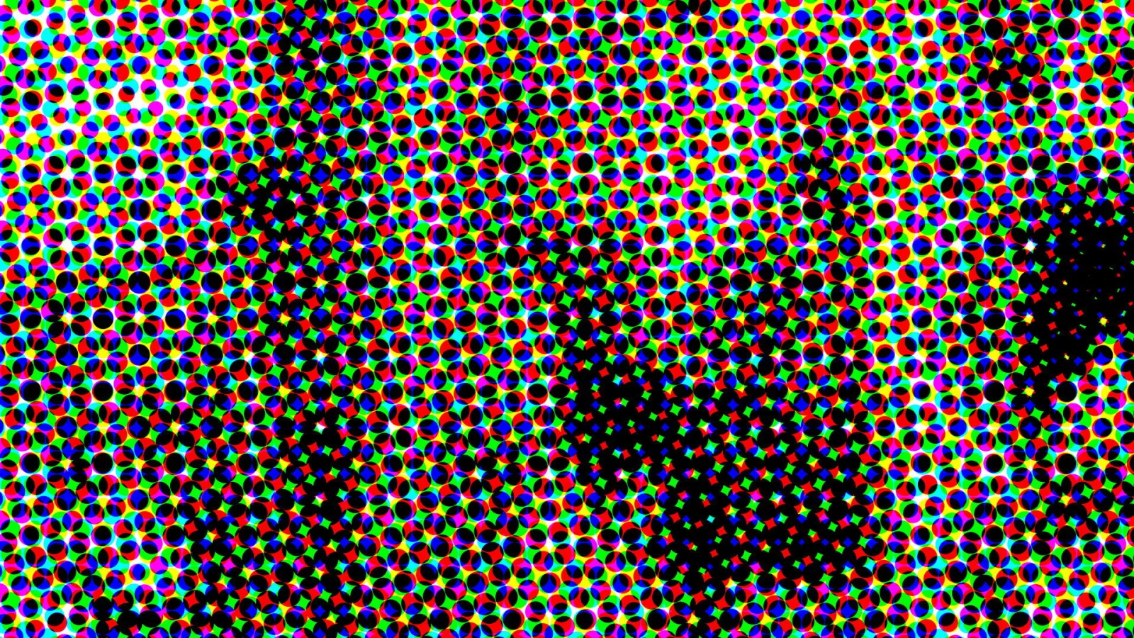 Dichtes Raster aus kleinen farbigen Punkten in Rot, Grün, Blau, Gelb und Magenta auf schwarzem Grund, im Zentrum und rechts unten verdichtet sich das Schwarz zu einem diagonalen Band.
