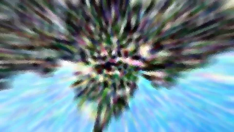 Palmwedel in Grün, Violett und Weiß vor blauem Himmel, radial verwischt und pixelig aufgelöst.