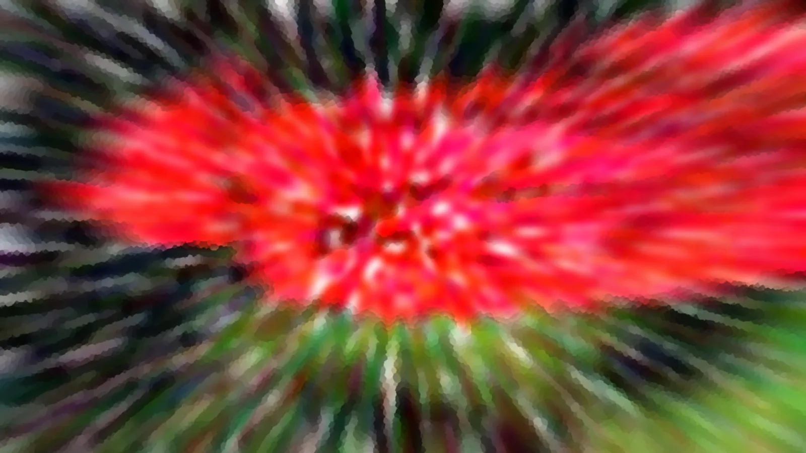 Abstrakte Aufnahme mit radialem Zoomeffekt: ein leuchtend rotes Zentrum, umgeben von grünen, dunklen und hellen Streifen, die nach außen strahlen.