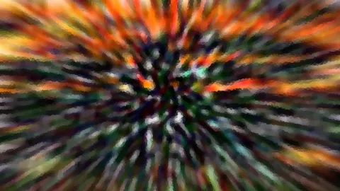 Abstraktes Bild mit radialen Streifen in Orange, Grün und Dunkelblau, die von einem dunklen Zentrum nach außen strahlen.