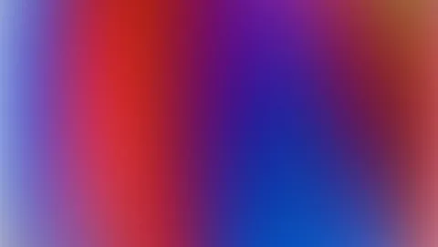 Verschwommener Farbverlauf von Rot über Violett bis Blau, von links nach rechts, mit hellen Blautönen am linken Rand und Orangetönen oben rechts.