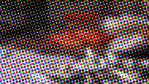 Dicht gesetztes Muster aus runden Punkten in Rot, Grün, Blau, Gelb und Cyan, das von dunklen Flächen links oben zu hellen Partien unten rechts übergeht.