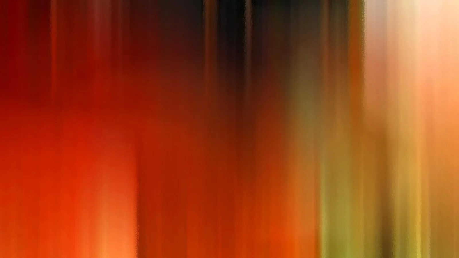 Vertikal verwischte Streifen in Rot, Orange und Gelb, oben dunkel, rechts hell