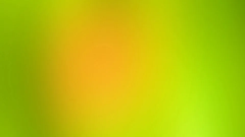Unscharfer Farbverlauf mit einem warmen orangefarbenen Zentrum, das nach außen in gelbes und grünes Licht übergeht.