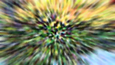 Abstraktes Bild mit radialem Zoomeffekt in Grün, Gelb und Blau, Farbschlieren laufen auf die Bildmitte zu.