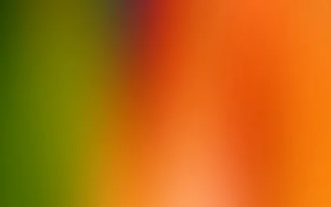 Unscharfer Farbverlauf von dunklem Grün links über Gelb zu Orange und Rot rechts, mit hellem Glanz unten in der Mitte.