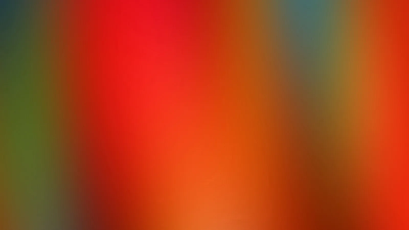 Unscharfer Farbverlauf mit dominantem Rot und Orange, am linken Rand grünlich, rechts oben blaugrau getönt.