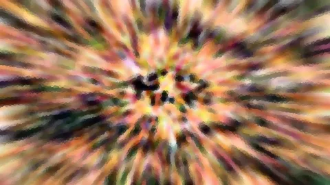 Abstraktes Bild mit radialer Bewegungsunschärfe in Orange, Gelb, Rosa und Grün, im Zentrum dunkle Flecken