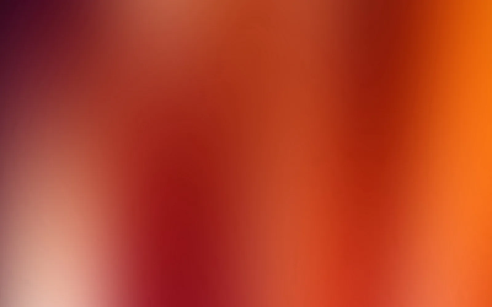 Unscharfer Verlauf von dunklem Weinrot über Rot bis zu hellem Orange, links unten ein heller Fleck.