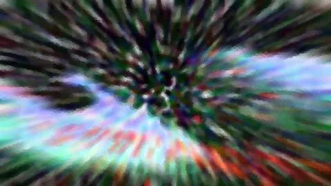 Abstraktes Bild mit bunten Schlieren in Grün, Blau und Rot, die von einem dunklen Zentrum radial nach außen laufen und grob verpixelt wirken.