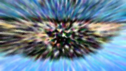 Abstrakte, radial verwischte Farbfläche mit Blau, Grün und Violett und einem dunklen, bunt gesprenkelten Zentrum.