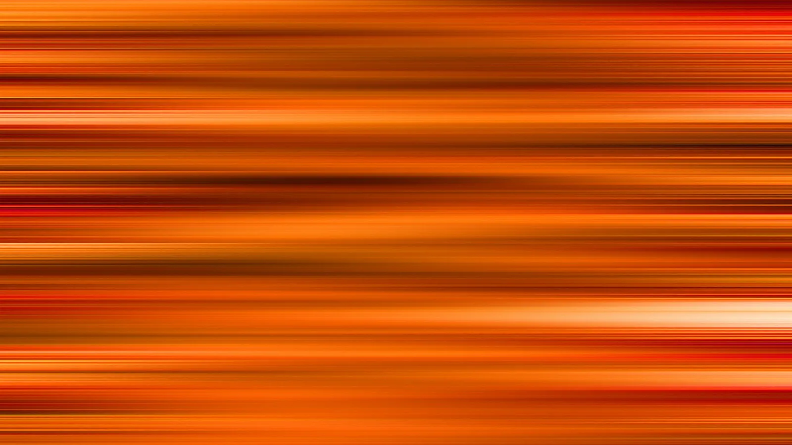 Abstraktes Bild aus waagerechten, unscharfen Streifen in Orange, Rot und Gelb, die dicht übereinanderliegen und Bewegung andeuten.
