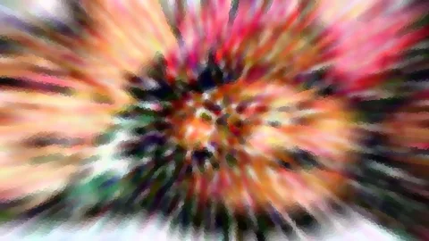 Abstrakte, radial verwischte Farbexplosion mit Rot, Gelb und Grün, im Zentrum ein kleines helles Muster.