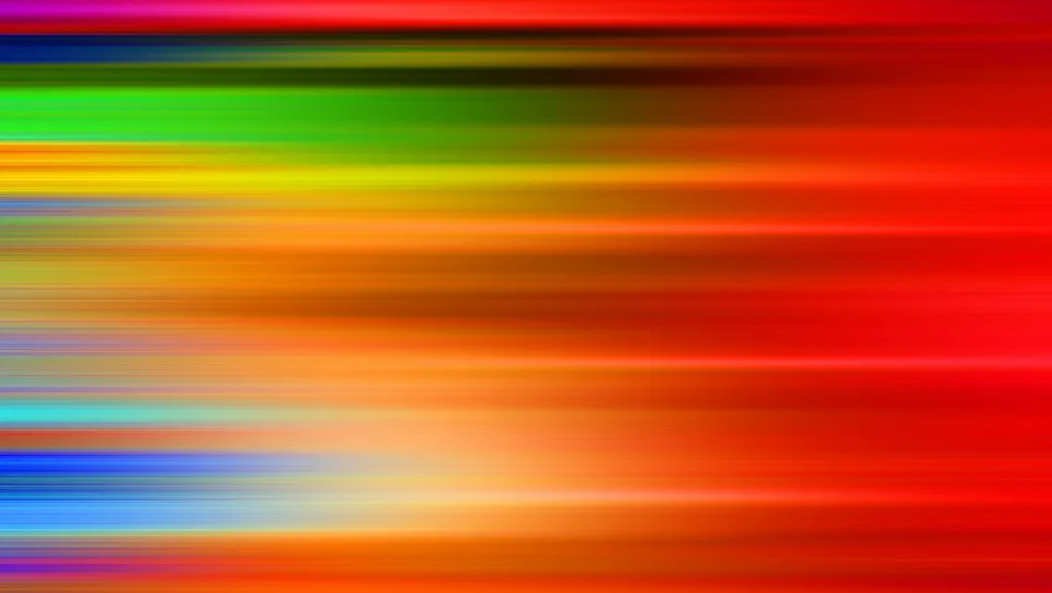 Abstraktes Bild aus waagerechten, verwischten Farbstreifen in Rot, Orange, Gelb, Grün und Blau, die nach rechts dichter und dunkler werden.