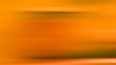 Horizontal verwischte Linien in Orange- und Gelbtönen mit dunkleren Streifen im oberen und unteren Bereich.