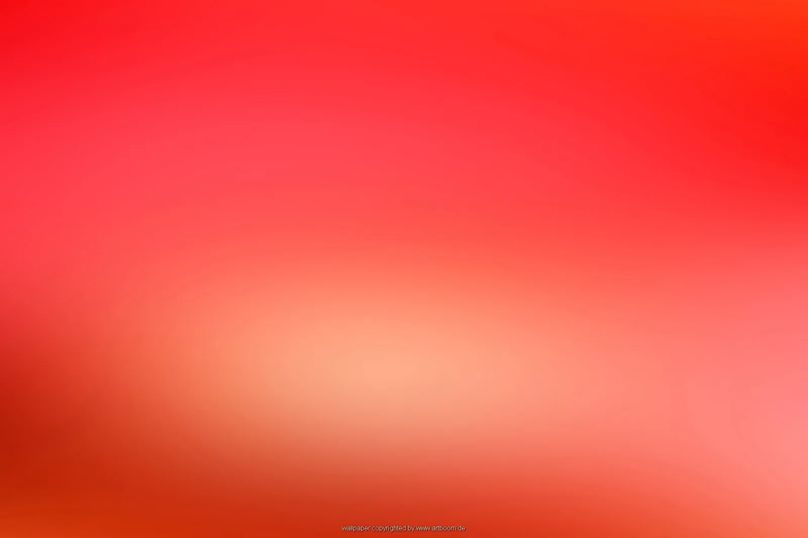 Unscharfer Verlauf von leuchtendem Rot über Rosa bis Orange, in der Mitte ein heller, warmer Schimmer.