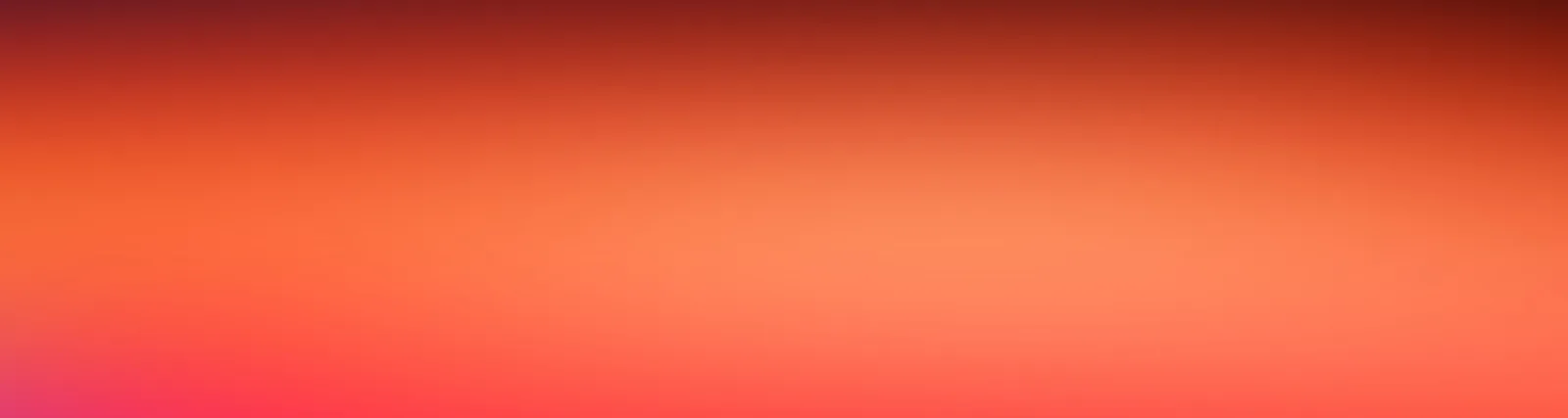 Weicher Farbverlauf von dunklem Rotbraun am oberen Rand über Orange bis zu Pink und Rot am unteren linken Rand.