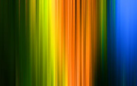 Abstrakte vertikale Streifen in Grün, Gelb, Orange und Blau, die von links nach rechts ineinander übergehen und durch Bewegungsunschärfe verwischt wirken.