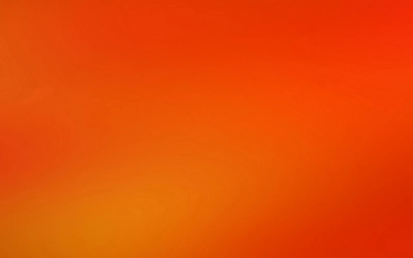 Unscharfer Farbverlauf von Rot oben nach Orange und Gelb unten links, ohne erkennbare Formen.