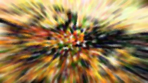 Abstrakte radiale Unschärfe mit gelben, orangen und grünen Farbstreifen, die vom Zentrum nach außen laufen, mit grobem Mosaikeffekt.