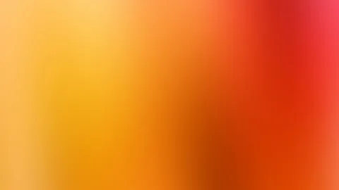 Unscharfer Farbverlauf von Gelb über Orange bis Rot, links hell, rechts dunkelrot mit einem pinken Rand oben rechts.
