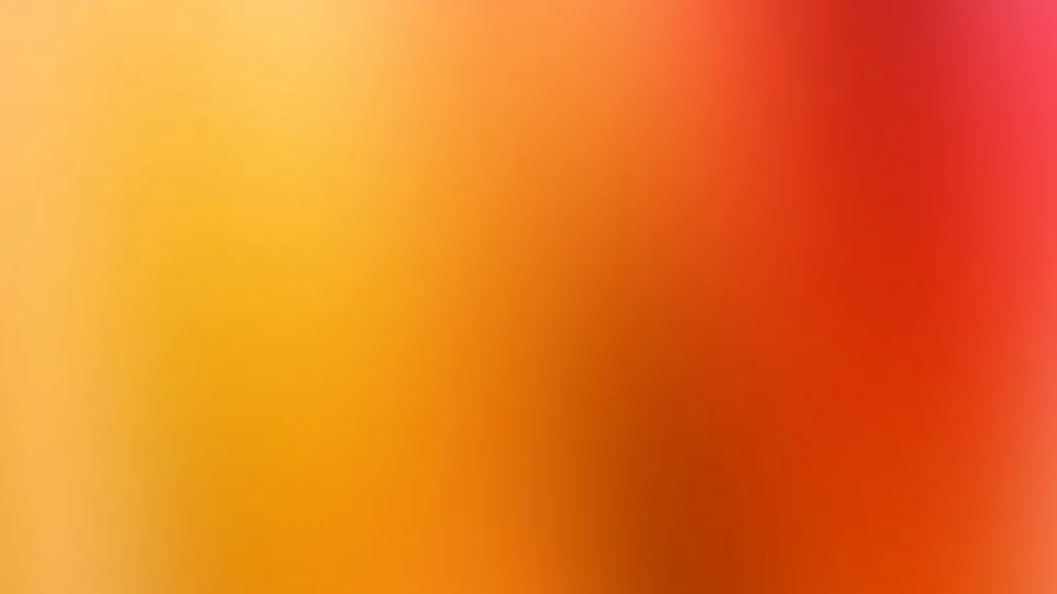 Unscharfer Farbverlauf von Gelb über Orange bis Rot, links hell, rechts dunkelrot mit einem pinken Rand oben rechts.