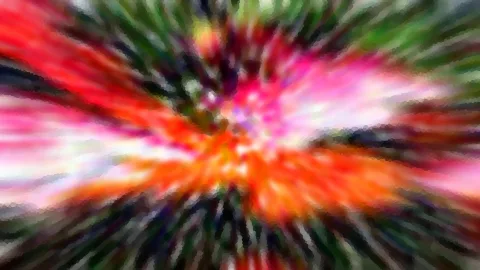 Abstrakte Farbexplosion aus Rot, Orange, Pink und Grün, die von der Mitte radial nach außen verwischt