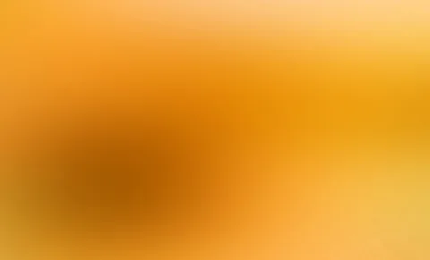 Unscharfer Farbverlauf in Orange und Gelb mit einem dunkleren braunen Schwerpunkt links der Mitte.