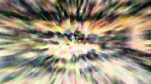 Abstrakte Komposition aus bunten, pastellfarbenen Streifen, die von einem hellen Zentrum radial nach außen laufen und unscharf wirken.