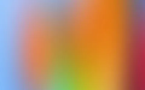 Unscharfer Farbverlauf von Blau links über Orange bis zu Rot rechts und Grün unten.