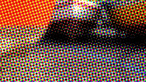Abstraktes Muster aus bunten Druckpunkten in Rot, Gelb, Grün und Blau, in der Mitte eine große schwarze Fläche.