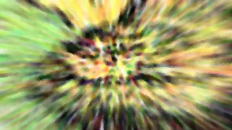 Abstrakte, radial verwischte Farbfläche in Grün, Gelb und Orange mit dunklen Akzenten und pixeligem Muster