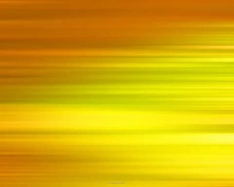 Horizontal verwischte Streifen, die oben in Orange und unten in leuchtendes Gelb mit grünlichen Übergängen übergehen.