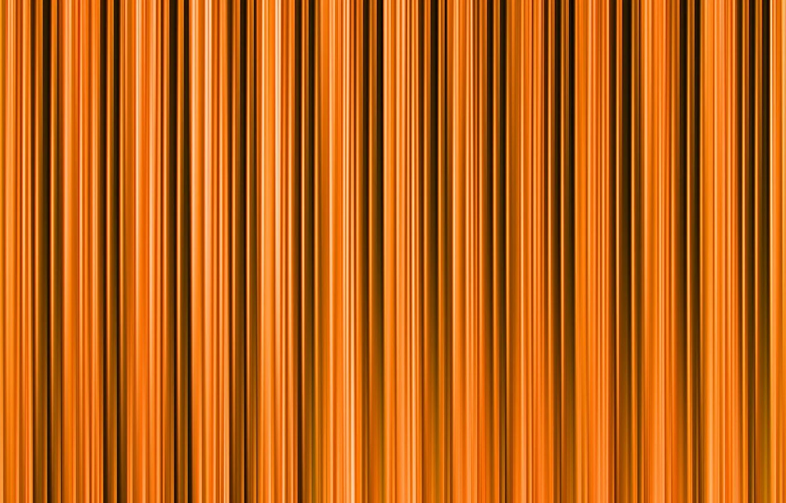 Dicht nebeneinander stehende vertikale Streifen in Orange, Rotorange und Dunkelbraun, leicht verschwommen wie in Bewegung.