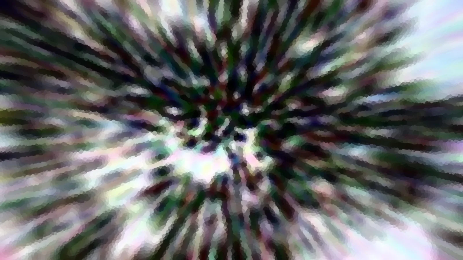 Abstrakte radiale Unschärfe mit grünen, violetten und weißen Streifen, die von einem hellen Zentrum nach außen laufen.