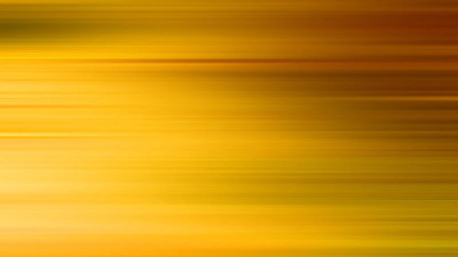 Horizontal verwischte Streifen in Gelb, Orange und Braun, rechts dunkler, links heller.