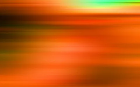 Verwischte horizontale Streifen in Orange, Braun und Grün, oben rechts ein heller grüner Schimmer.