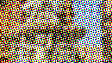 Dichtes Raster aus farbigen Punkten in Rot, Grün, Blau, Gelb, Cyan und Magenta auf weißem Grund, in der Mitte verdichtet sich das Muster zu einer dunklen, verschwommenen Form.
