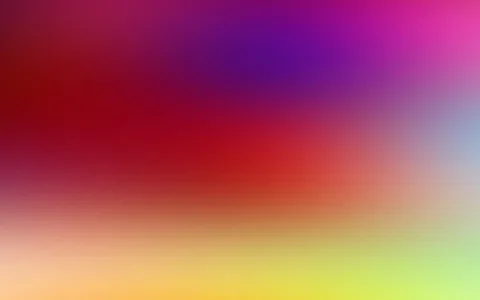 Unscharfer Farbverlauf von Rot über Violett und Pink bis zu Gelb und Hellgrün, oben rechts ein blasses Blau.