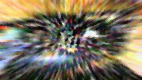 Abstraktes Bild mit radialem Zoomeffekt: Farbstreifen in Gelb, Grün, Violett und Weiß laufen von den Rändern zur Mitte, die von einem dunklen, körnigen Zentrum gebildet wird.