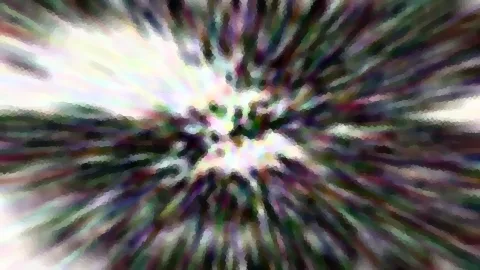 Abstrakte Zoomaufnahme mit radialen Farbstreifen in Grün, Lila und Weiß, im Zentrum ein heller Lichtfleck.