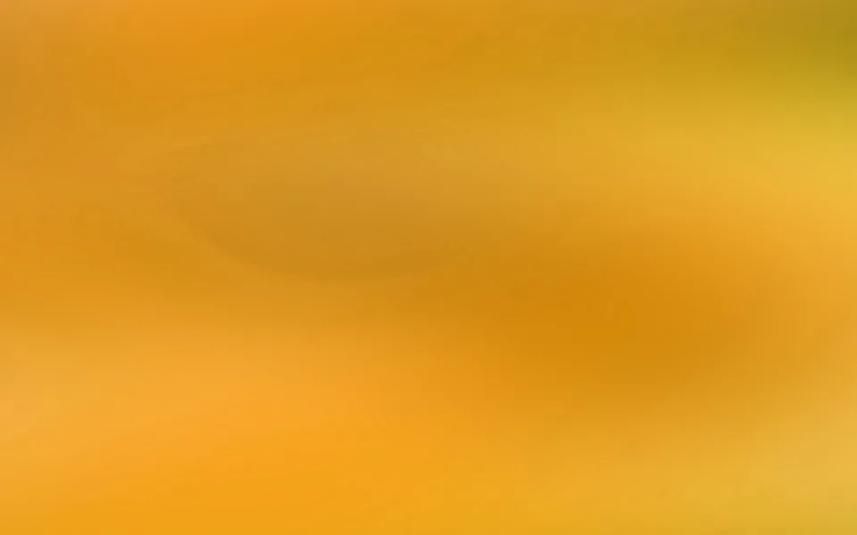 Weich verlaufende Fläche in Orange- und Gelbtönen mit dunkleren, verschwommenen Bereichen in der Mitte und unten.