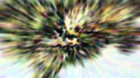 Abstraktes Bild mit radialer Unschärfe: bunte Streifen in Grün, Gelb, Violett und Weiß laufen von einem dunklen Zentrum nach außen.